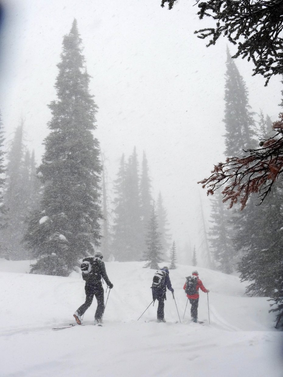 Steamboat Powdercats guide Eric Haskell leads Liz and Bob Forster up Soda Mountain.