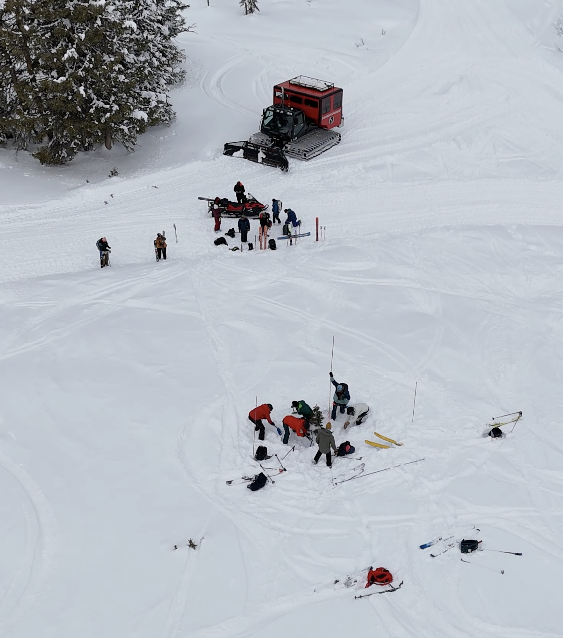 A group on the snow working on an avalanche rescue course